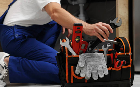 Gas Safe engineer from Blue8 Gas Services checking boiler pressure during home visit.
